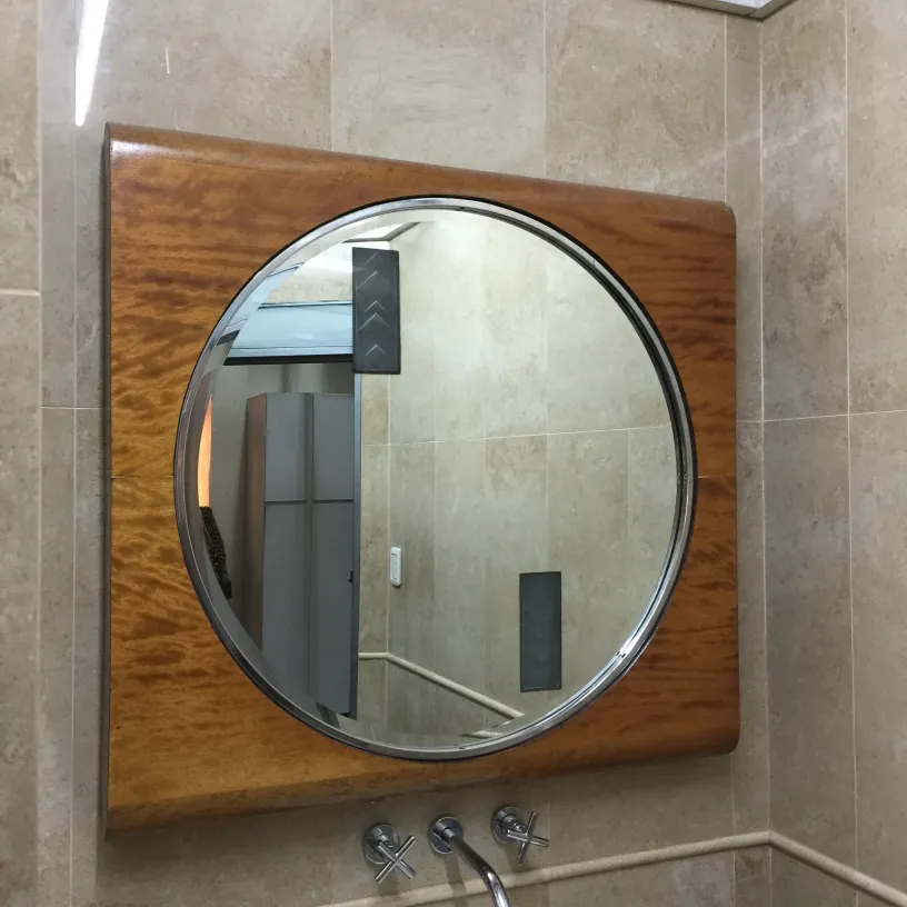 antique round mirror in a modern bathroom