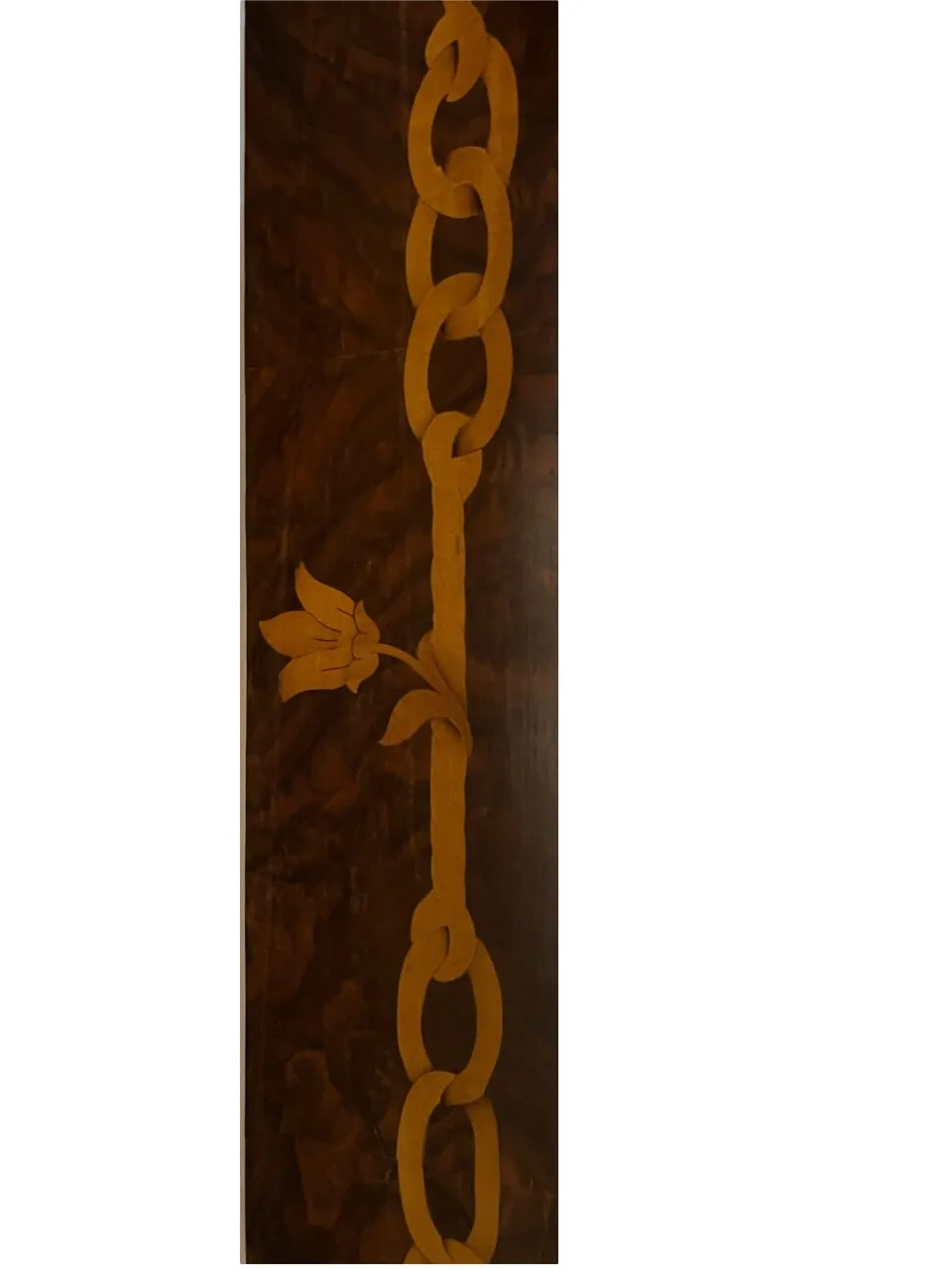 antique mirror decorated with a floral design on a dark background