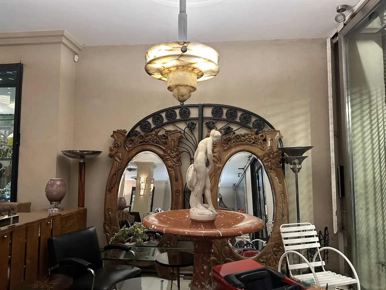 Antique mirror in Art Nouveau style with decorative frame.