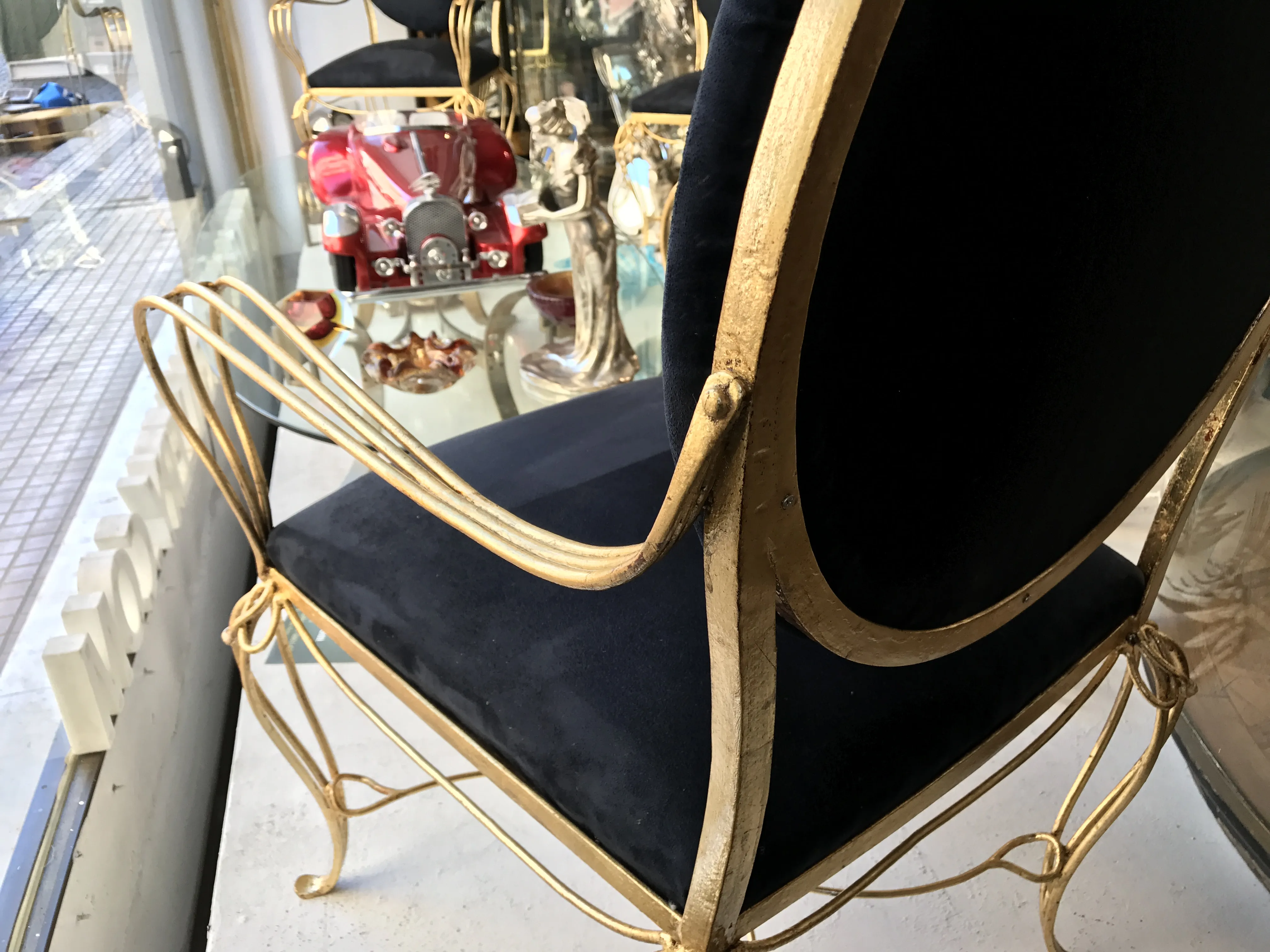 golden chair with blue upholstery in antique setting