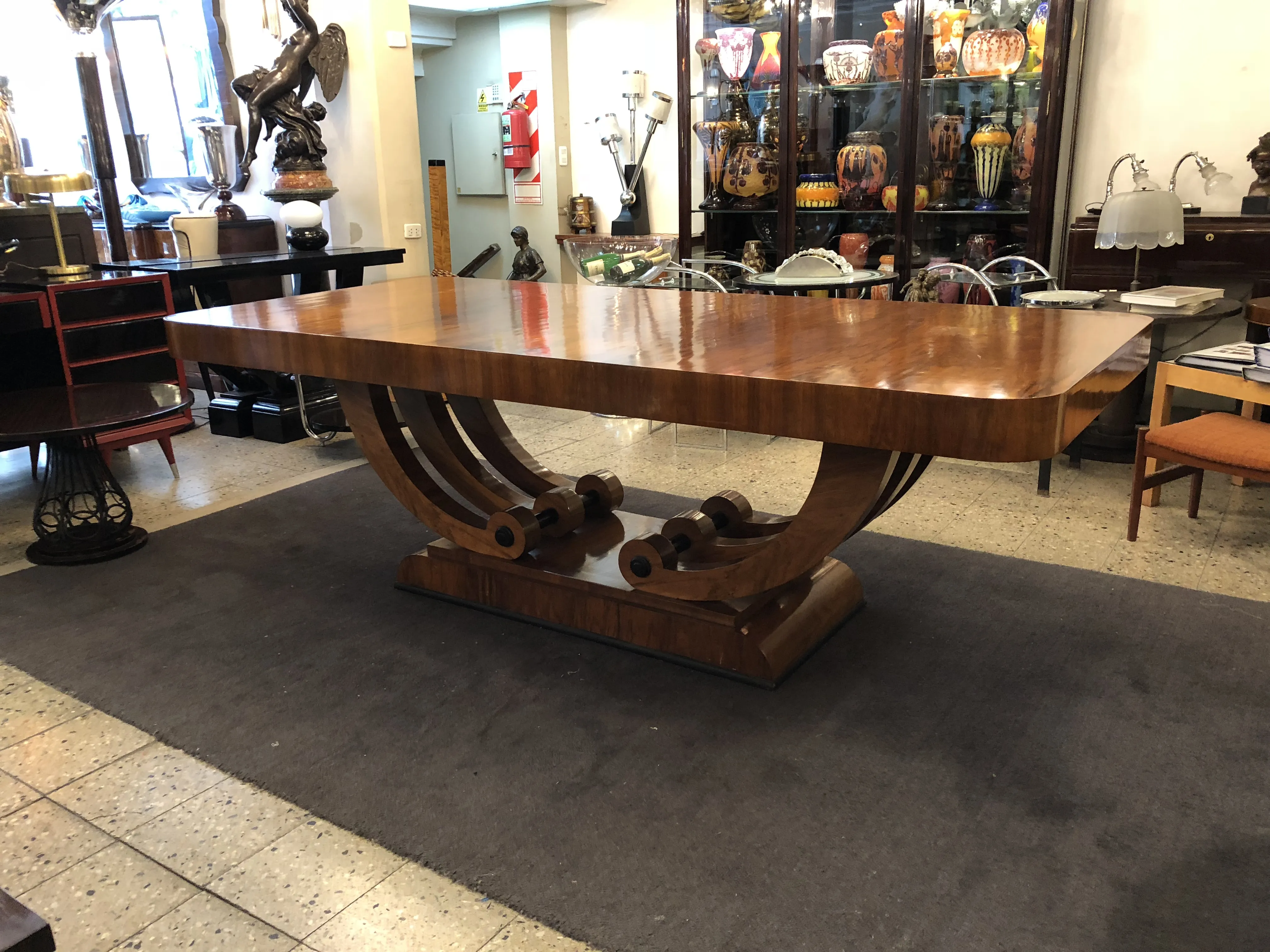 Antique Art Deco dining table for 10 people, set in a stylish environment.