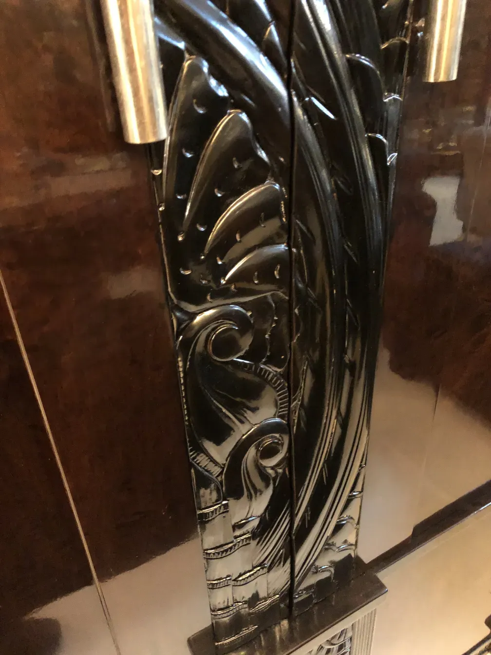 antique bookcase with raised decoration and metal details