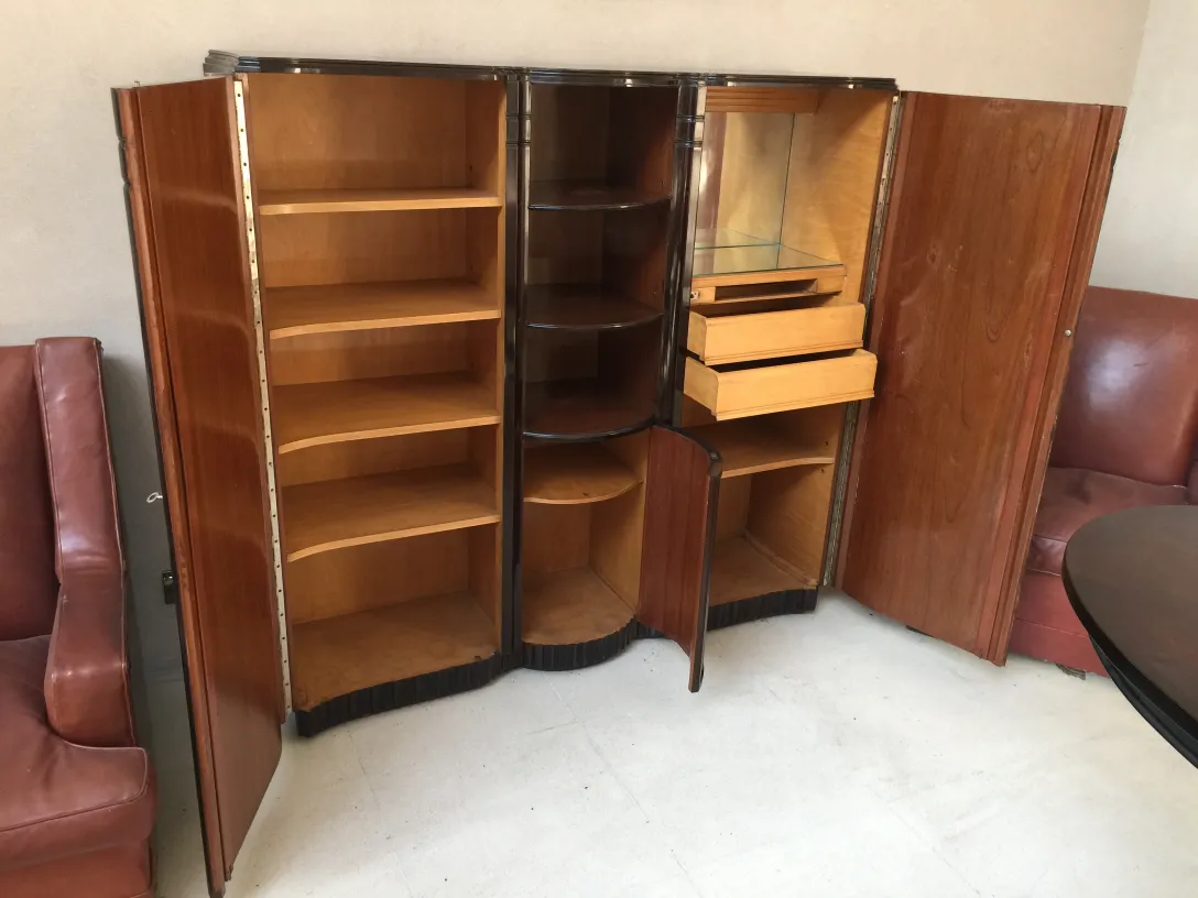 Antique bookcase with polished finishes, wide shelves, and drawers