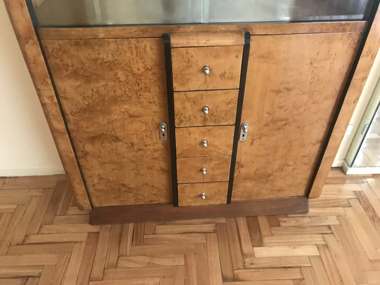 antique bookcase with ornamental details and visible shelves
