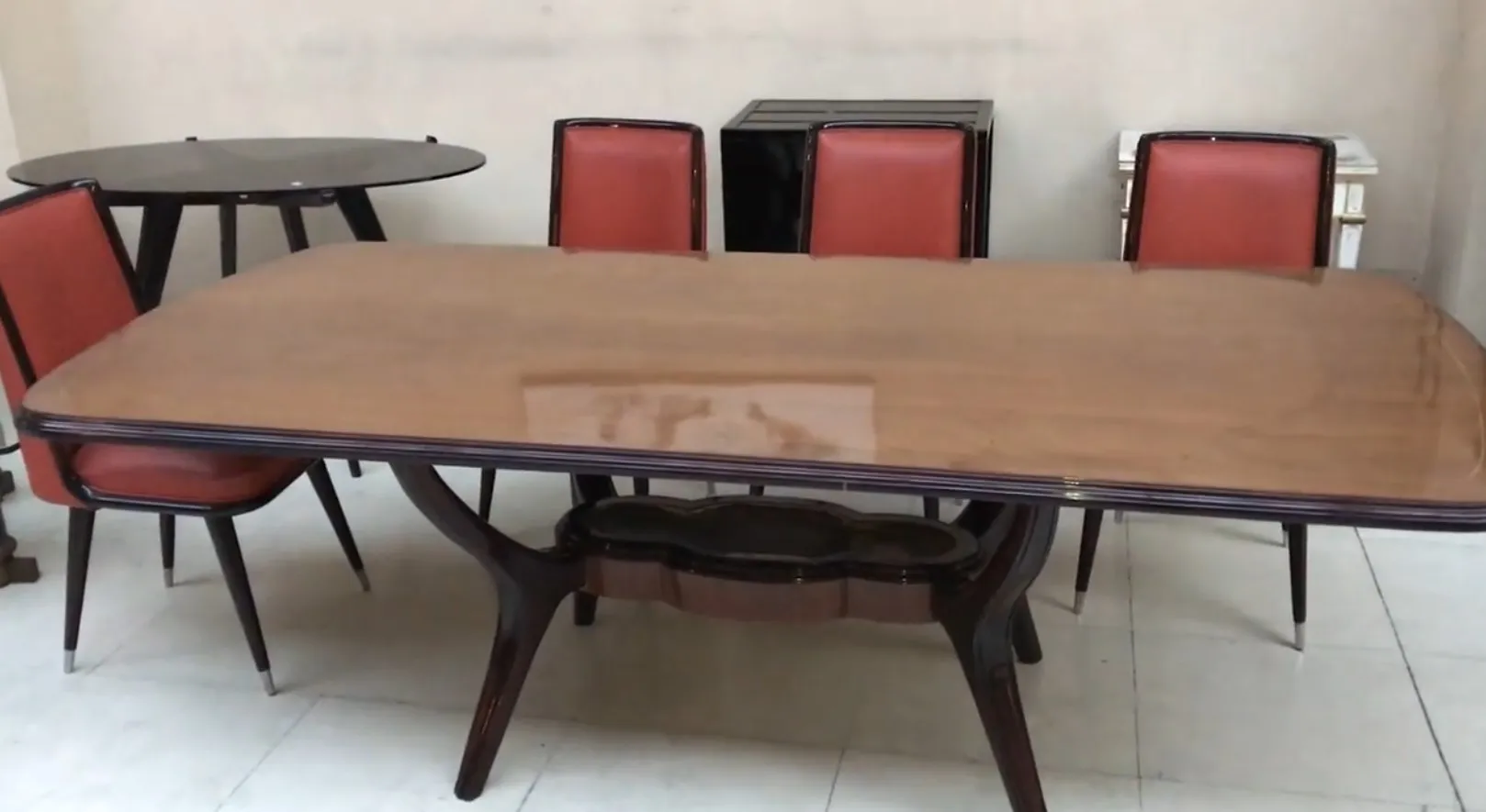 Mesa de jantar antiga para 8 pessoas, design atraente, cadeiras estofadas em vermelho, ambiente aconchegante.