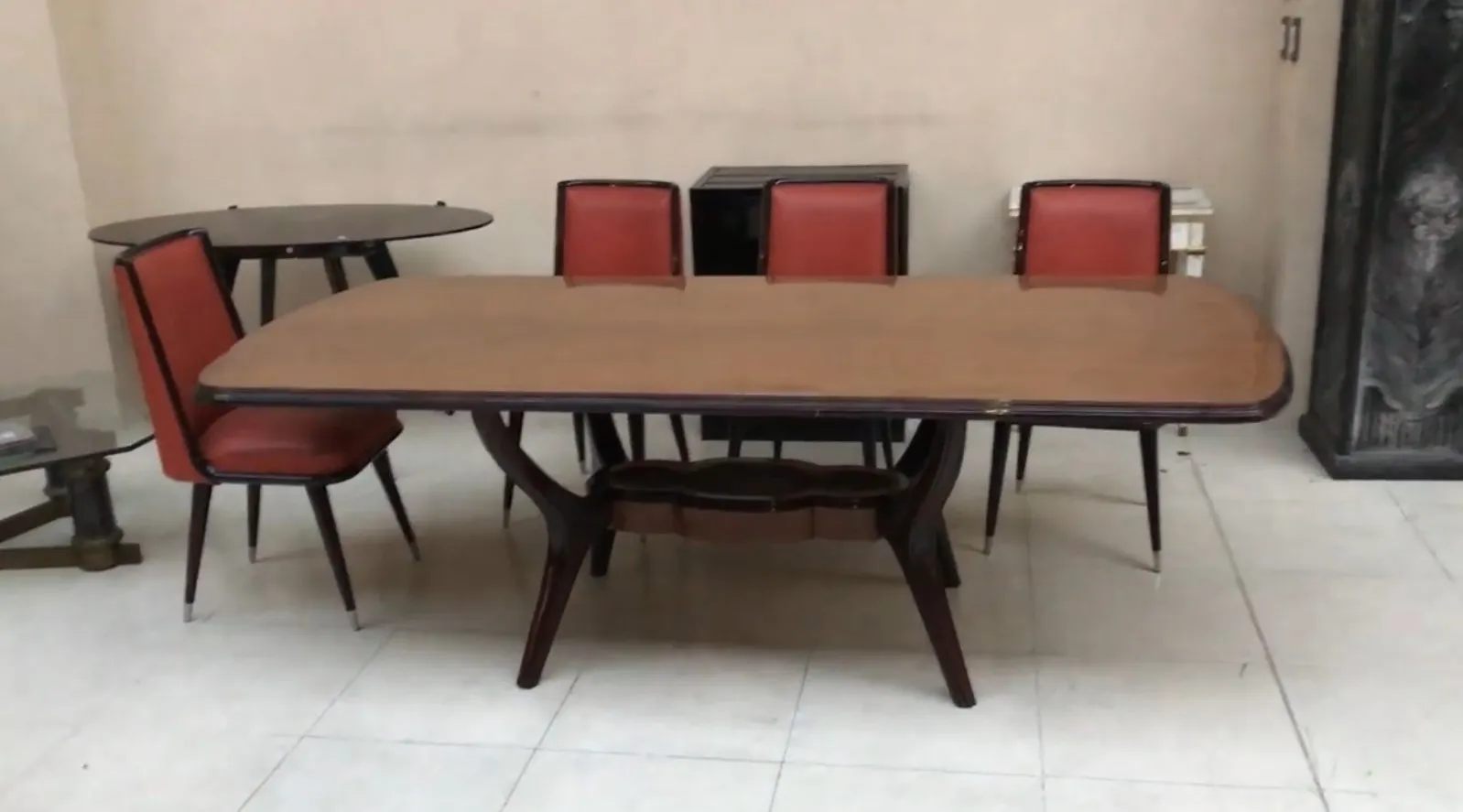 Antique dining table from 1950 for eight people with red chairs