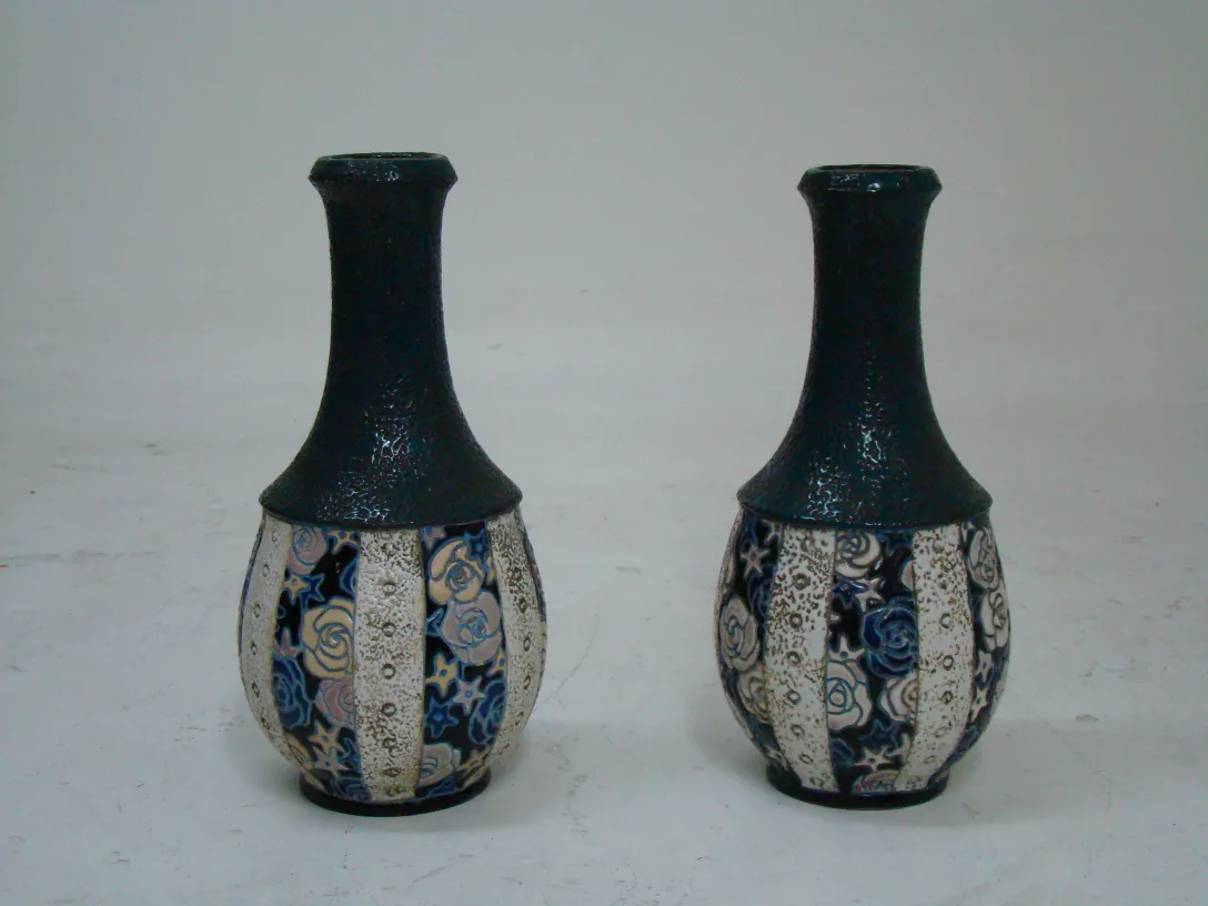Two antique decorative ceramic pieces with floral patterns in blue and cream colors.