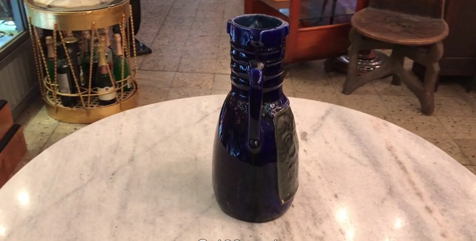 blue antique ceramic jug on white table