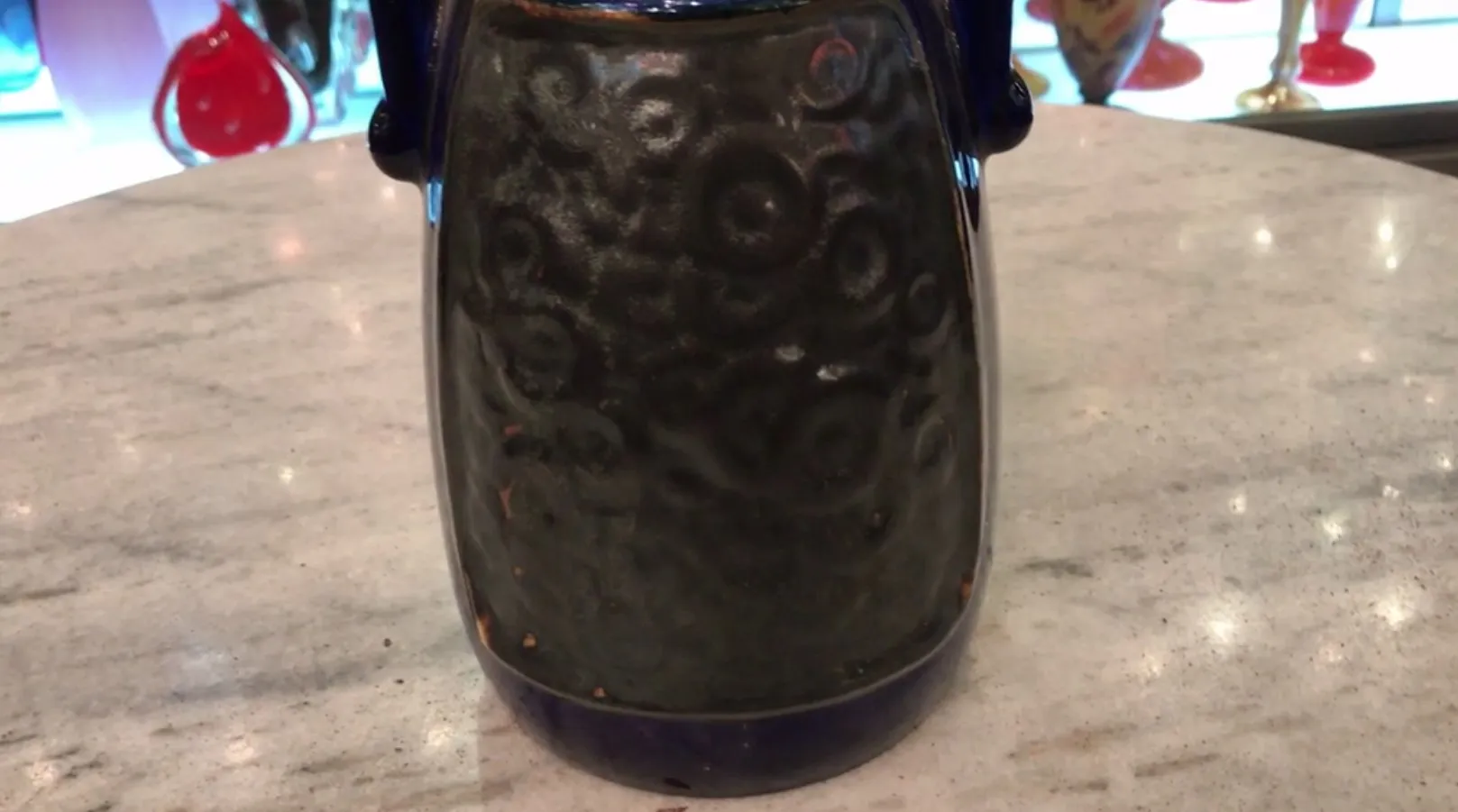 Antique ceramic with detailed surface, soft background