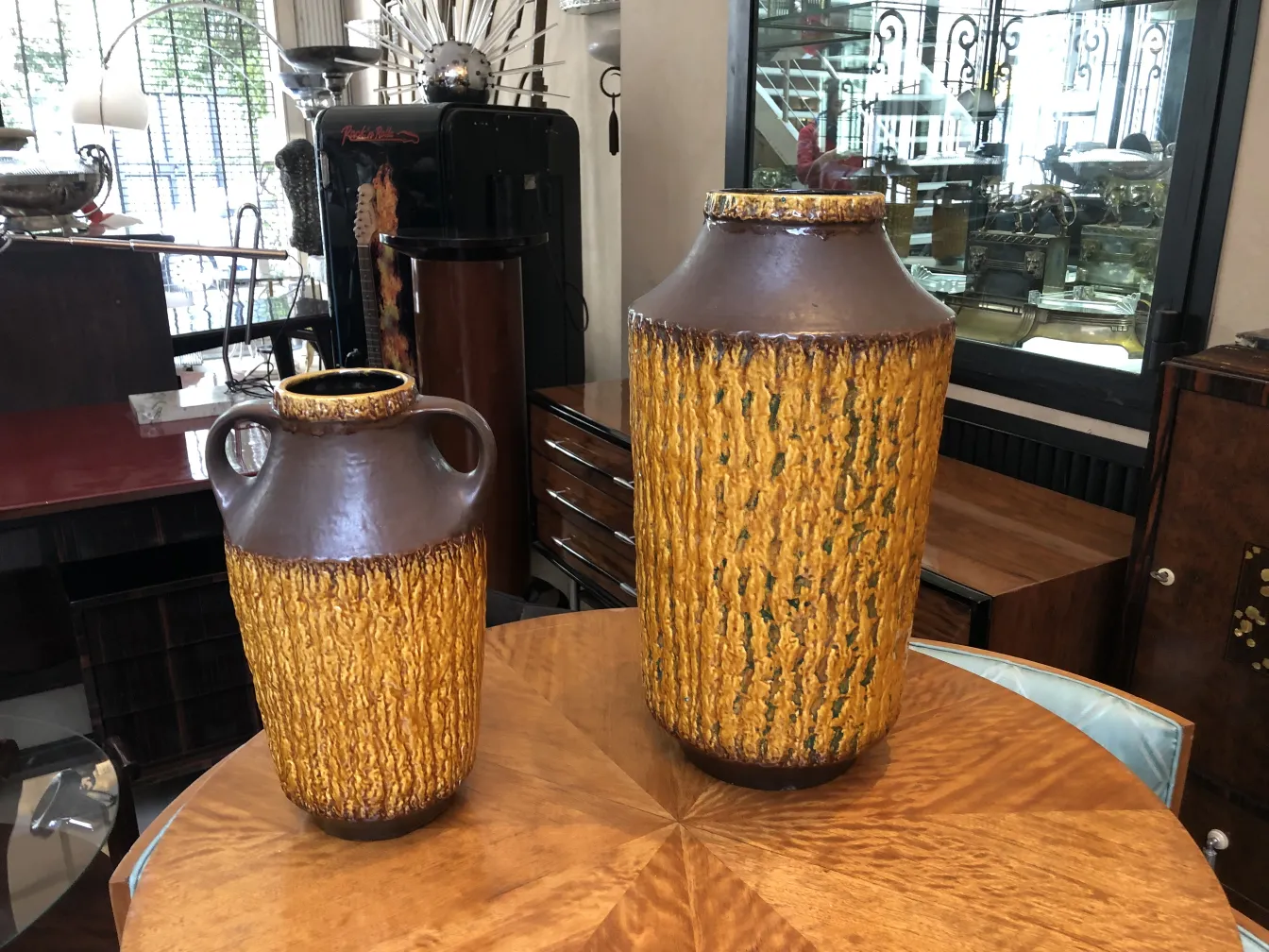Dos jarrones antiguos de cerámica decorativa en un entorno elegante.