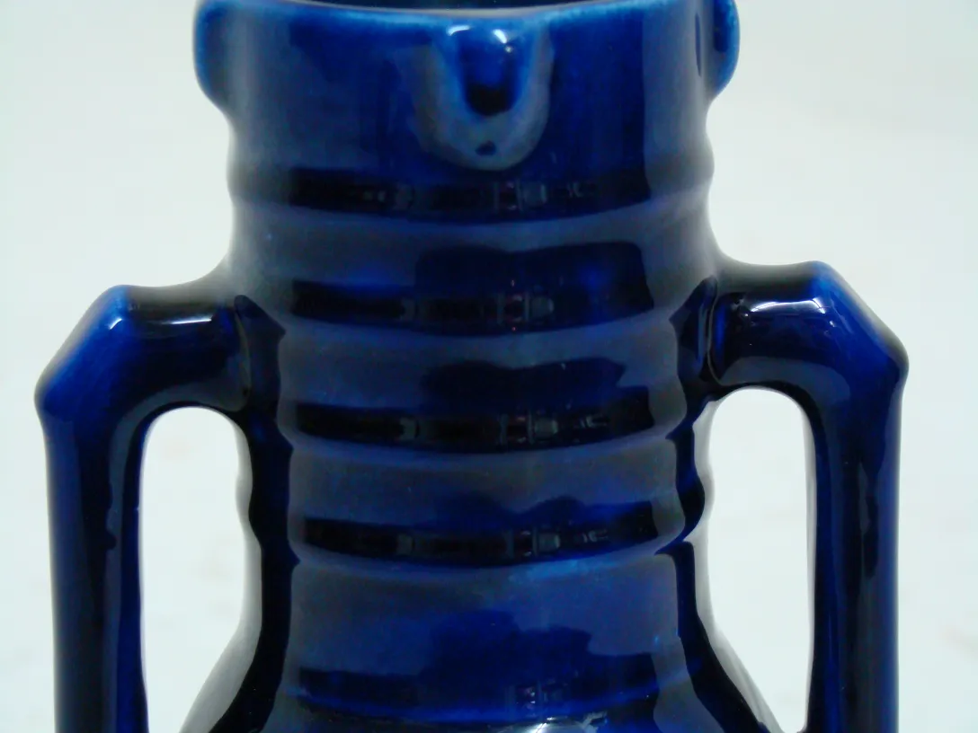 Antique blue ceramic jar with embossed details