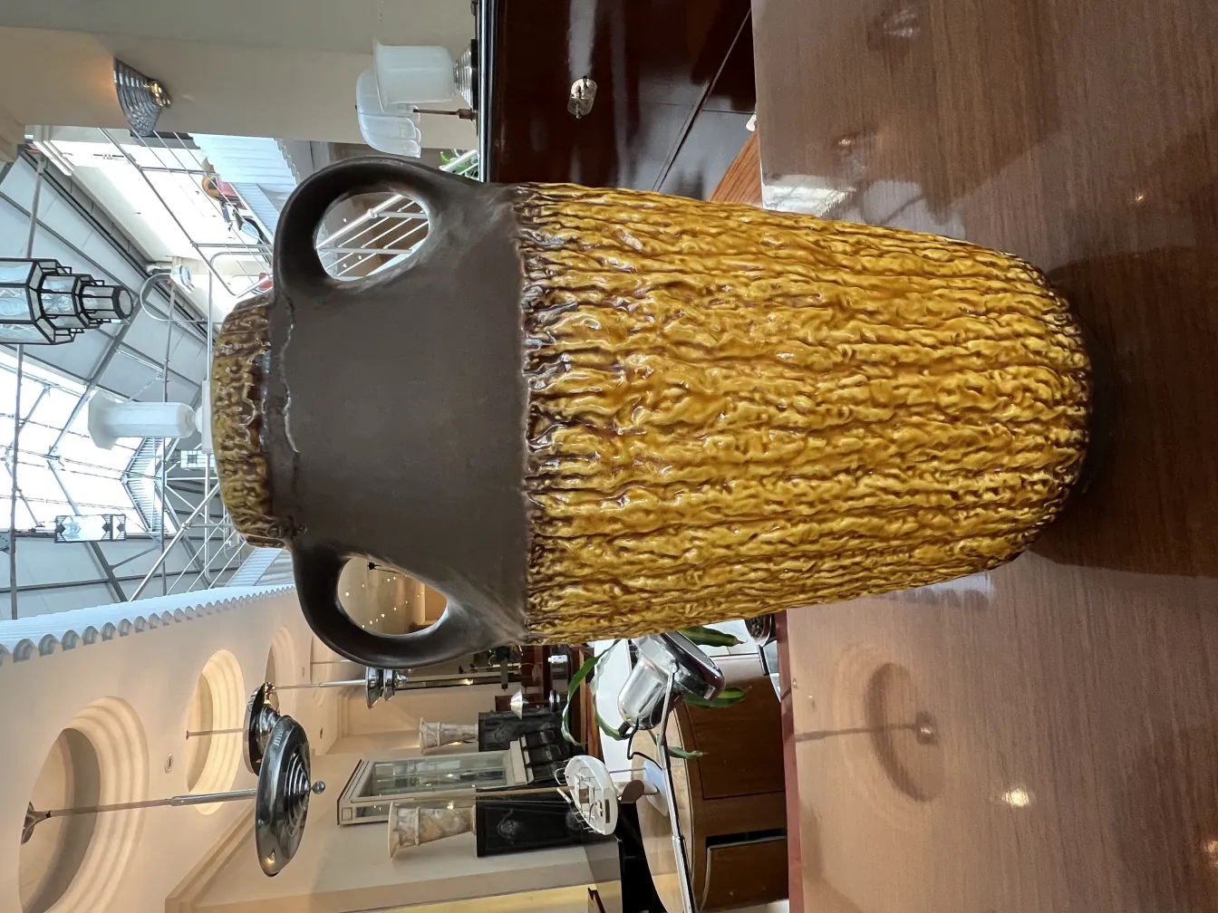 Antique ceramic vase with yellow and brown texture, decorative details