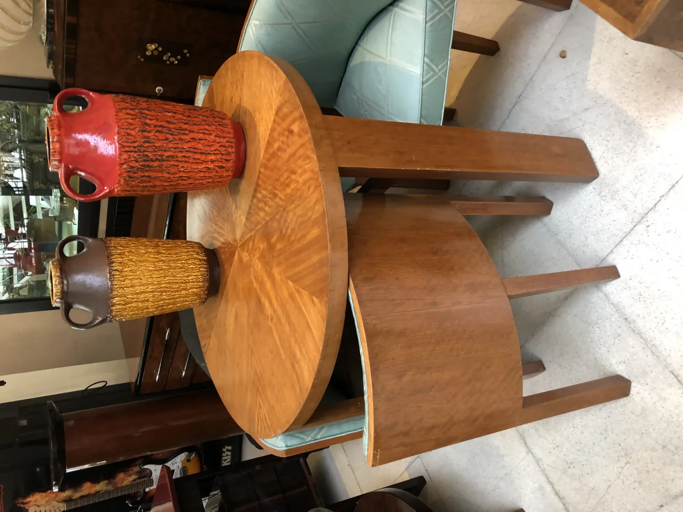 Two vintage decorative ceramic vases on a wooden table.