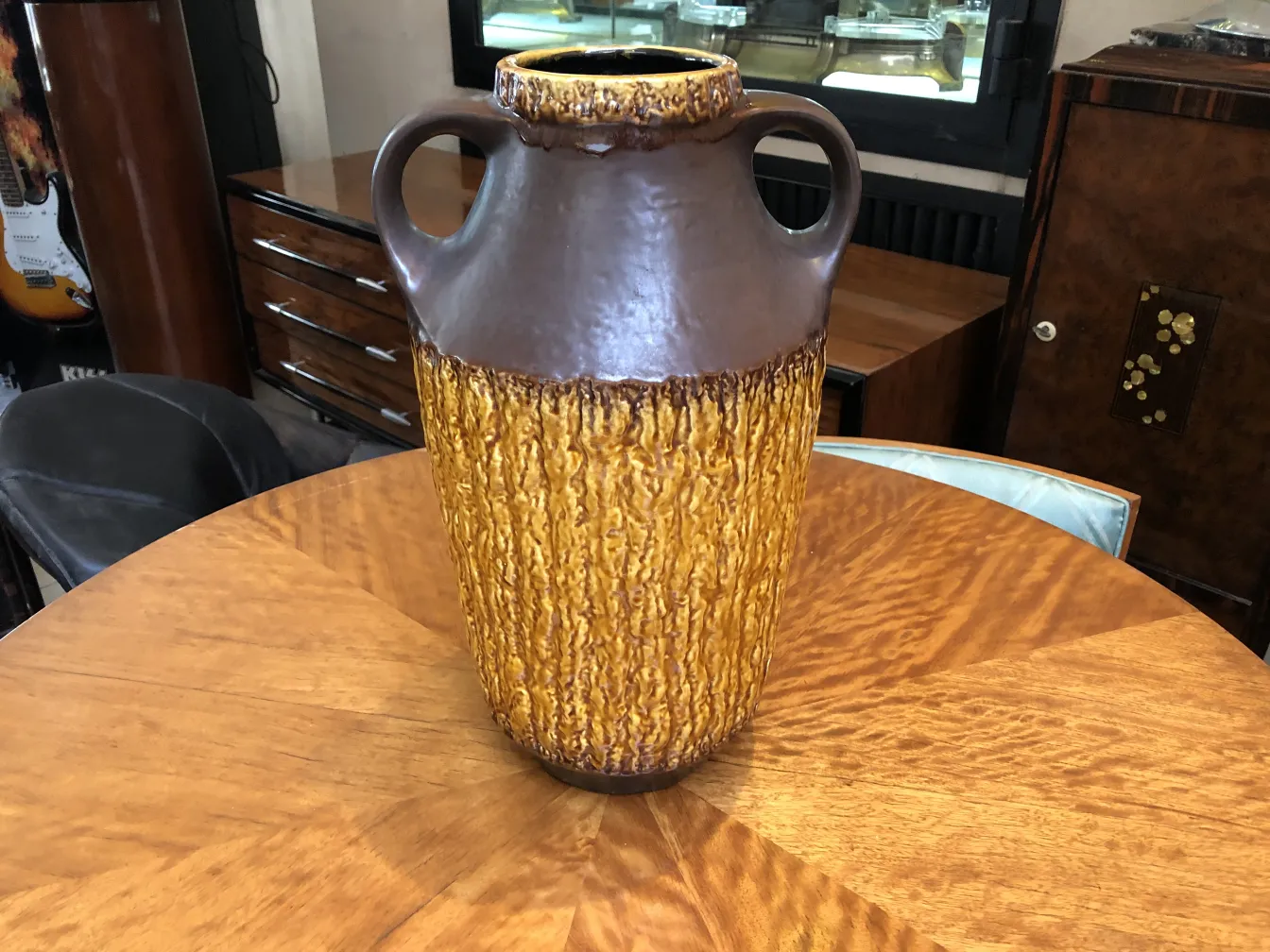 antique ceramic with textures in brown and yellow on wooden table