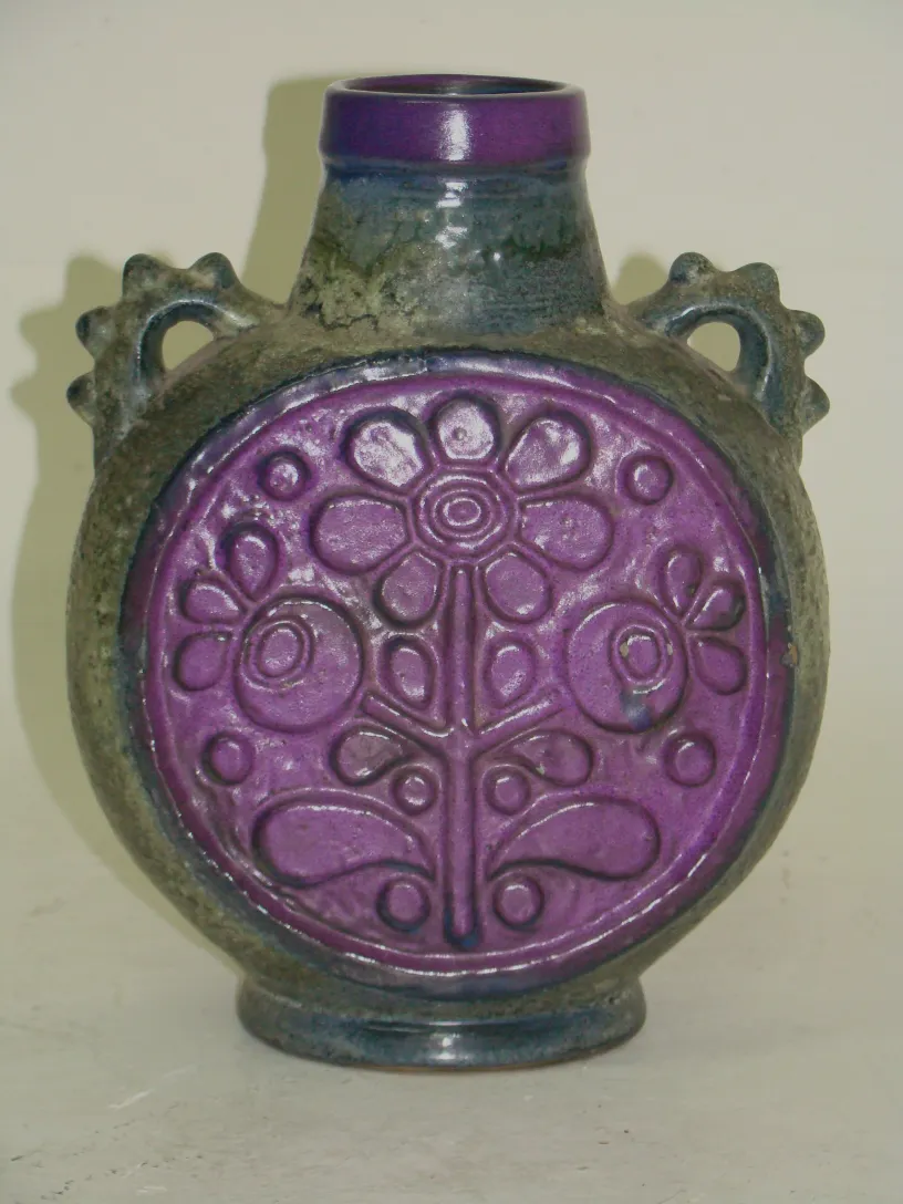 antique ceramic bottle with purple floral relief
