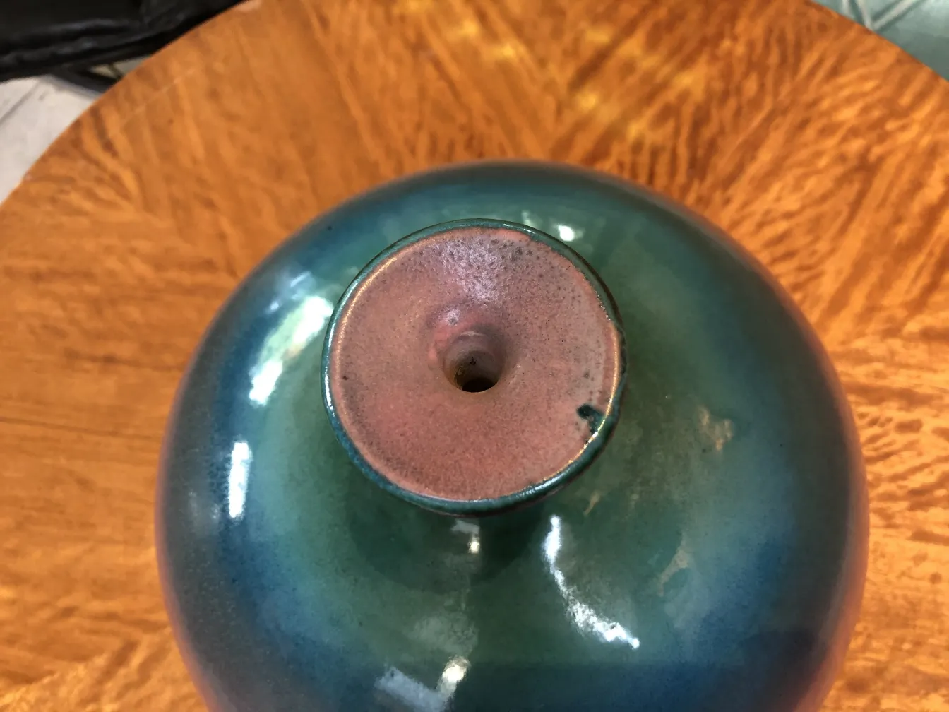 Top view of an antique emerald ceramic vase with a shiny finish.