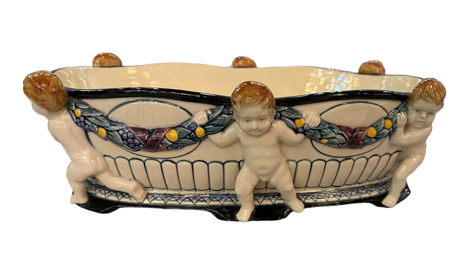 Antique ceramic by Karlsruhe Majolica Manufacture featuring decorative figures.