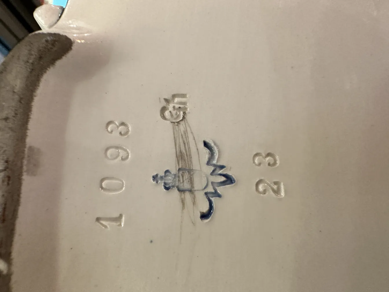 antique ceramic with decorative design and distinct markings