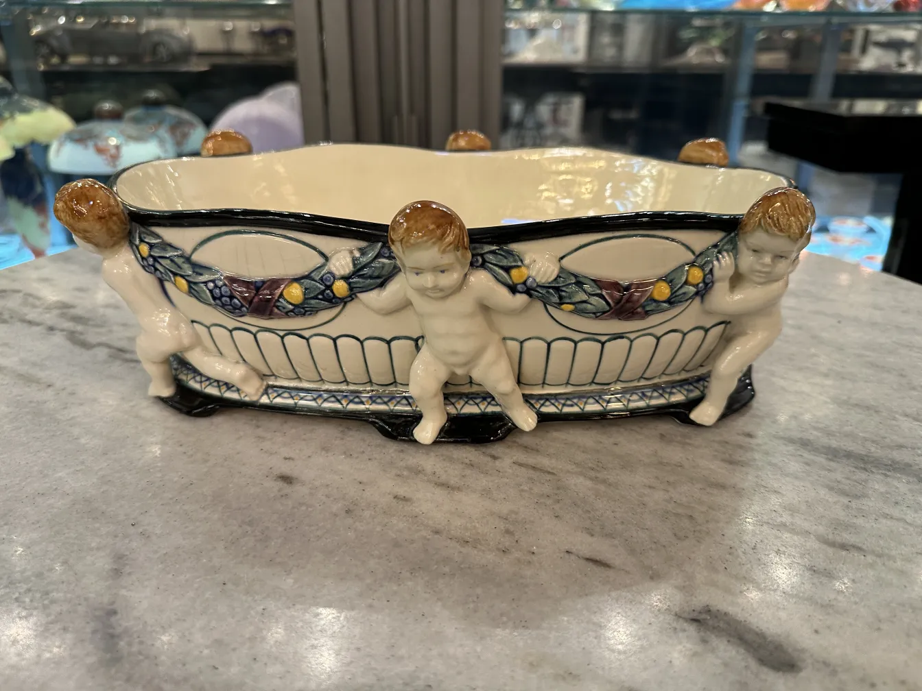 Antique ceramic featuring child figures, white with blue details.