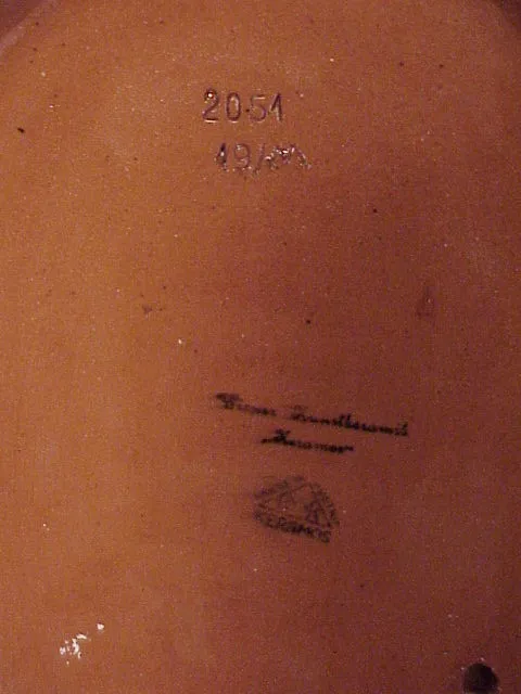 Antique ceramic with stamped design and artistic details.