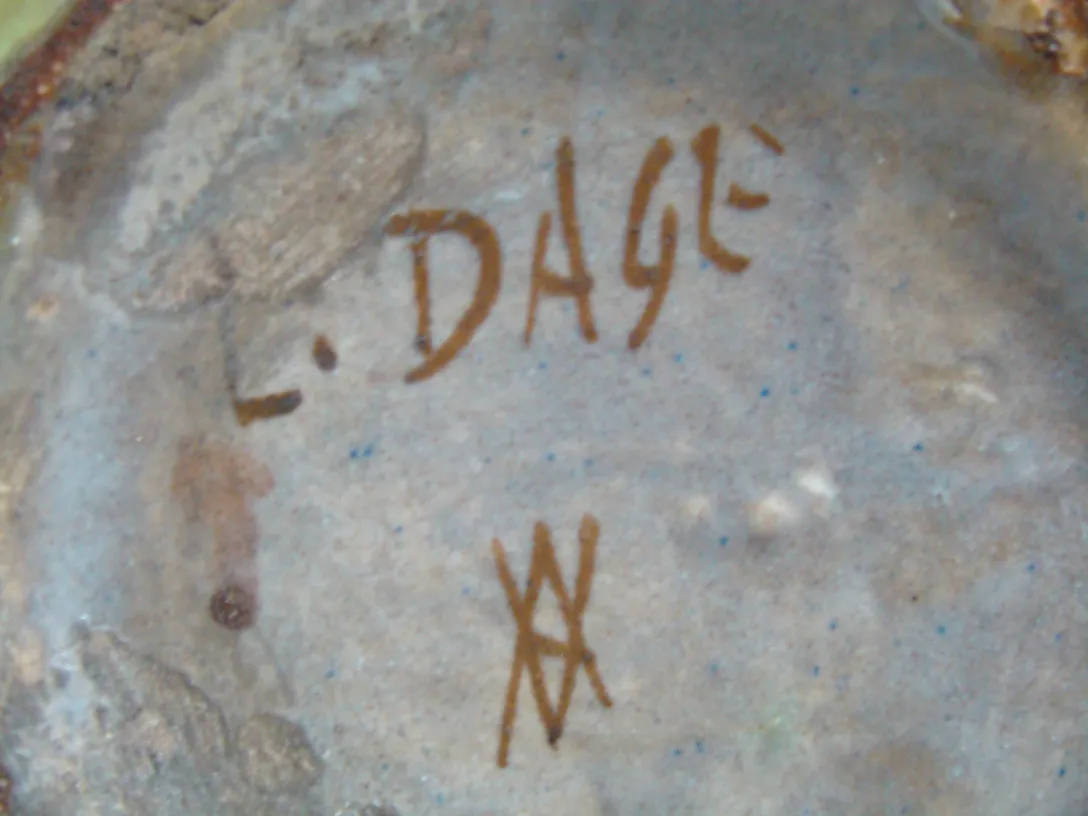 Ancient ceramic piece with a visible inscription in irregular style, featuring earthy tones against a soft background.