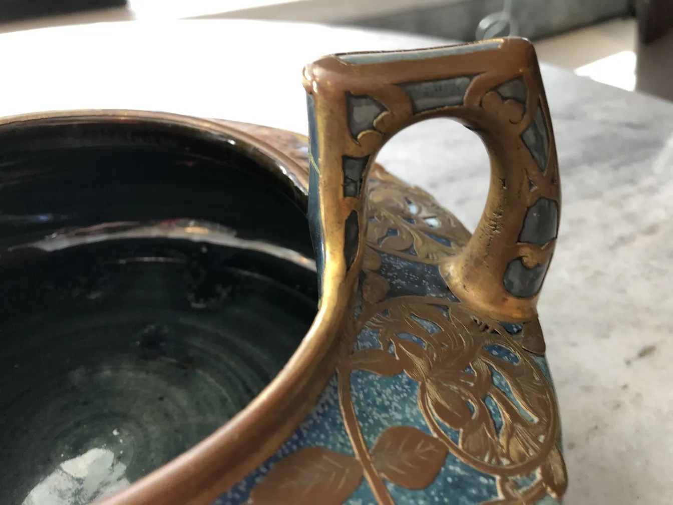 antique ceramic with a decorated handle and blue color