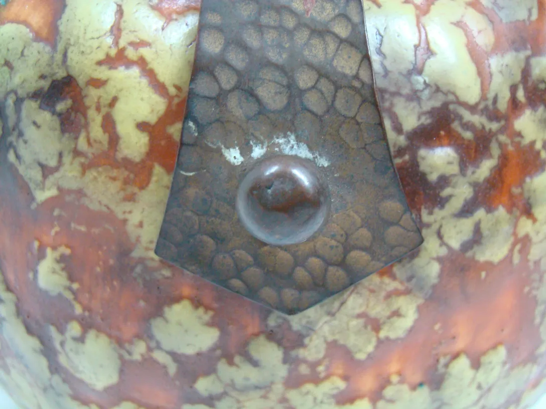 Cerâmica antiga decorativa com tons marrons e amarelos