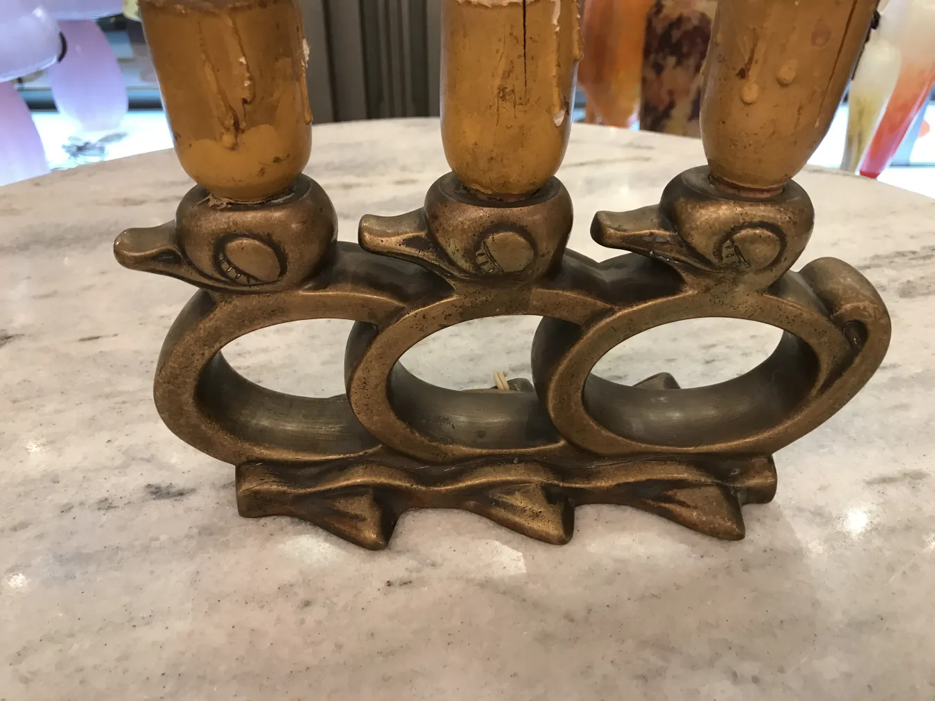 Antique table lamp with bird-shaped base, decorative details, and cozy ambiance.