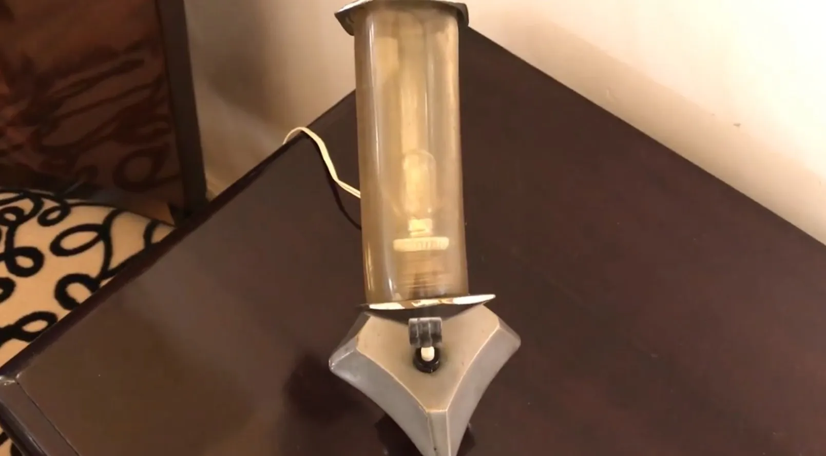 Antique table lamp featuring soft lighting in a cozy environment.