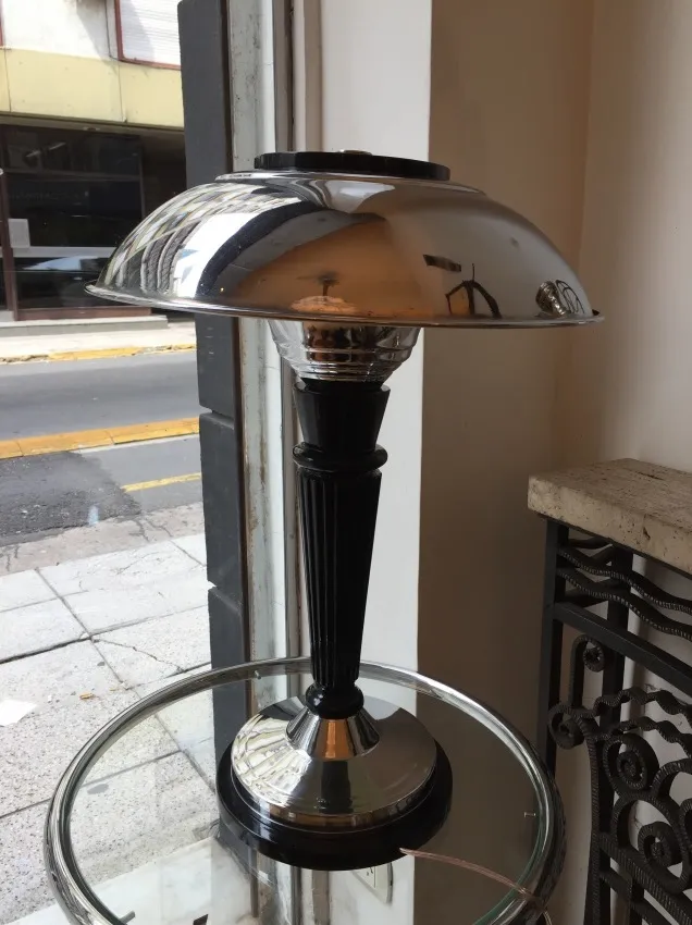 antique table lamp featuring an elegant design and black base, illuminating a cozy space