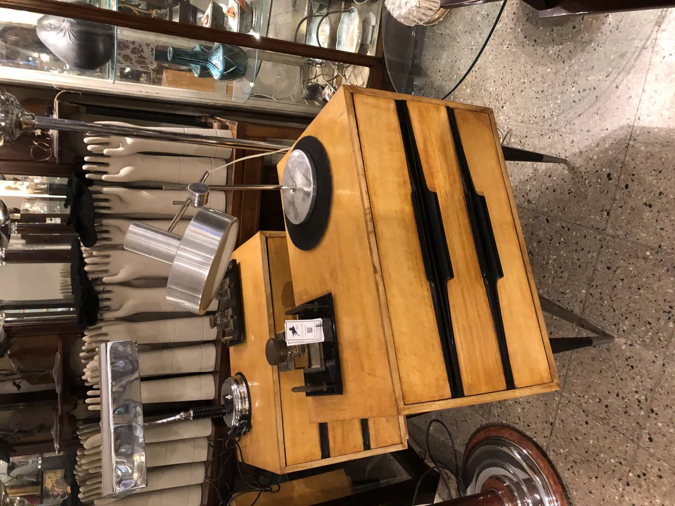 Lampe de bureau antique avec une forme élégante et une couleur argentée, entourée d'autres objets