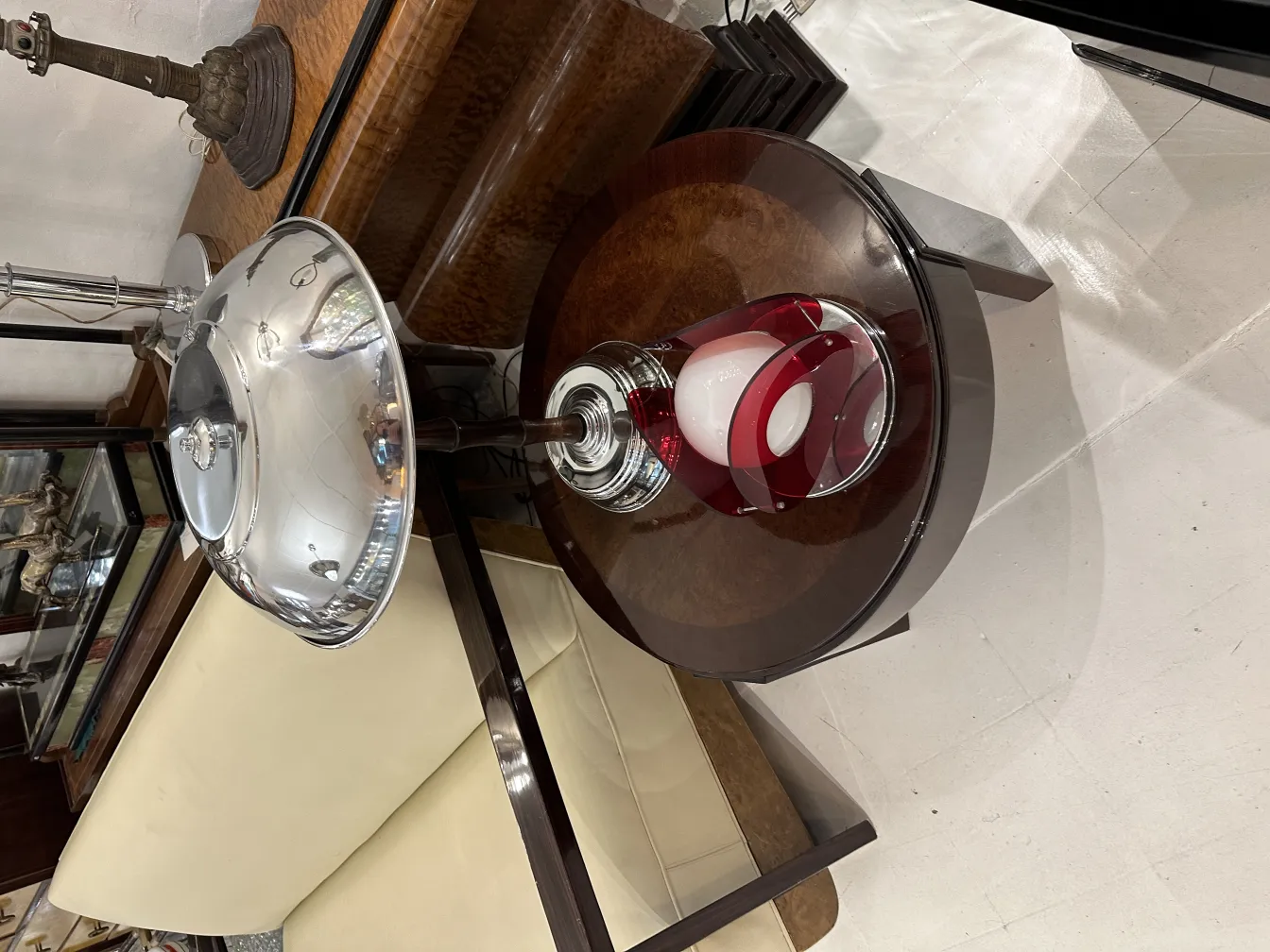 antique table lamp with an elegant design and red shade, in a cozy setting