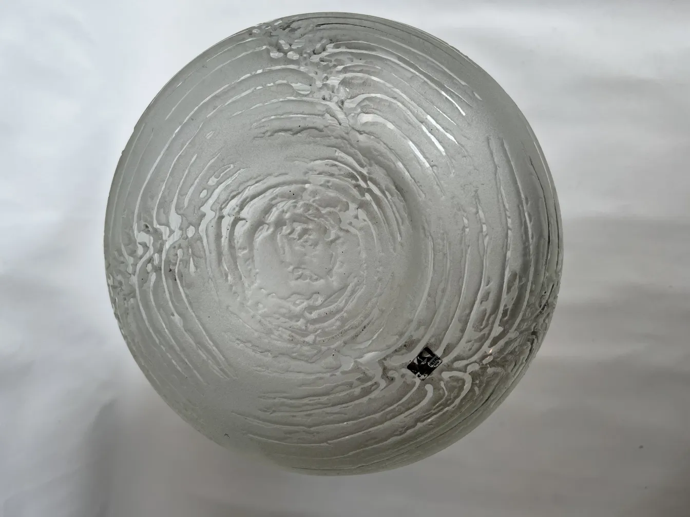 Antique table lamp featuring a circular design and glass base, enhancing a vintage setting