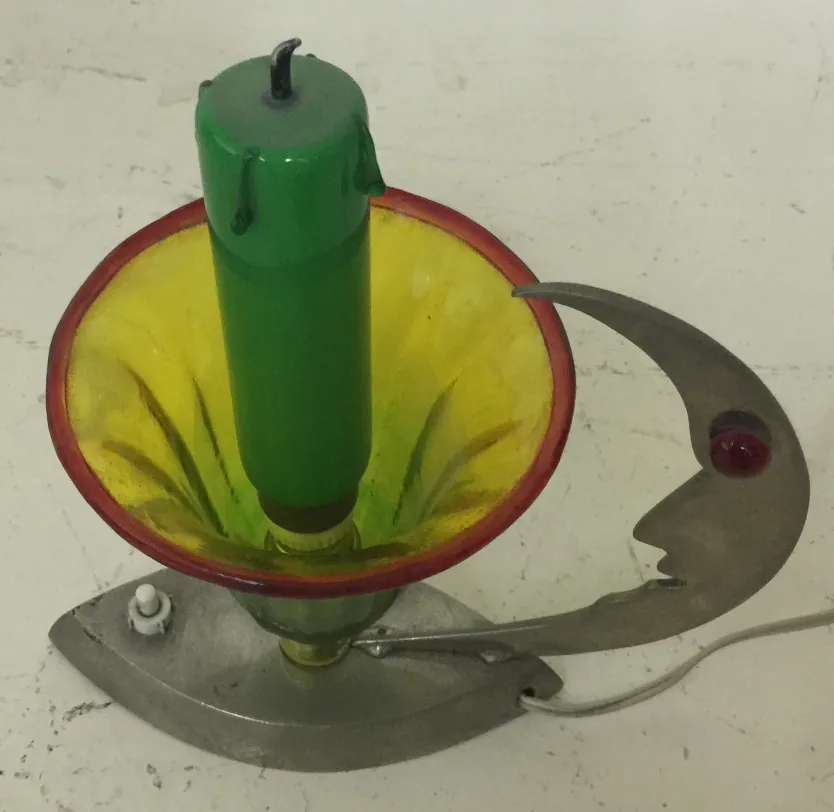 Antique table lamp with metal base and yellow shade.