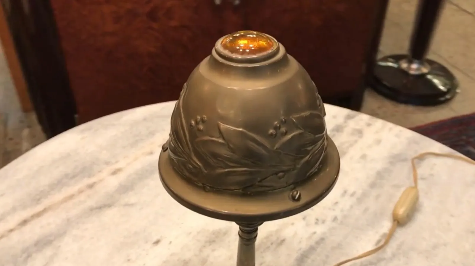 Antique table lamp featuring floral design and warm light