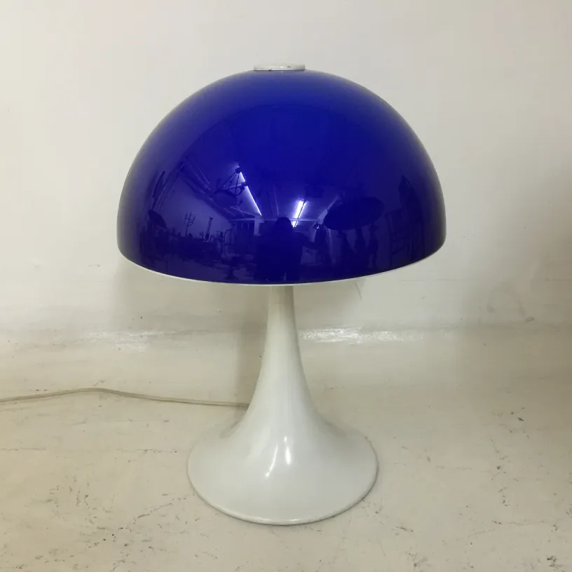 Antique table lamp with a sleek shiny blue shade, perfect for enhancing decor.