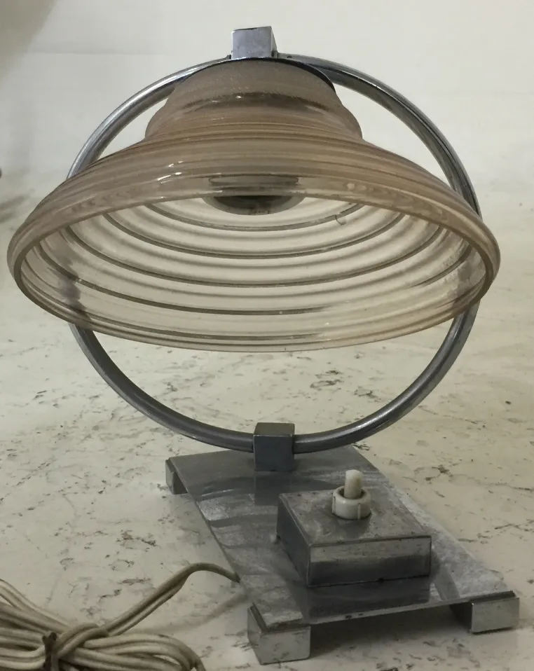 Antique table lamp featuring a circular design and light diffuser, perfect for decor.
