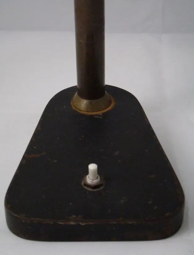 black base and pole of an antique table lamp with switch