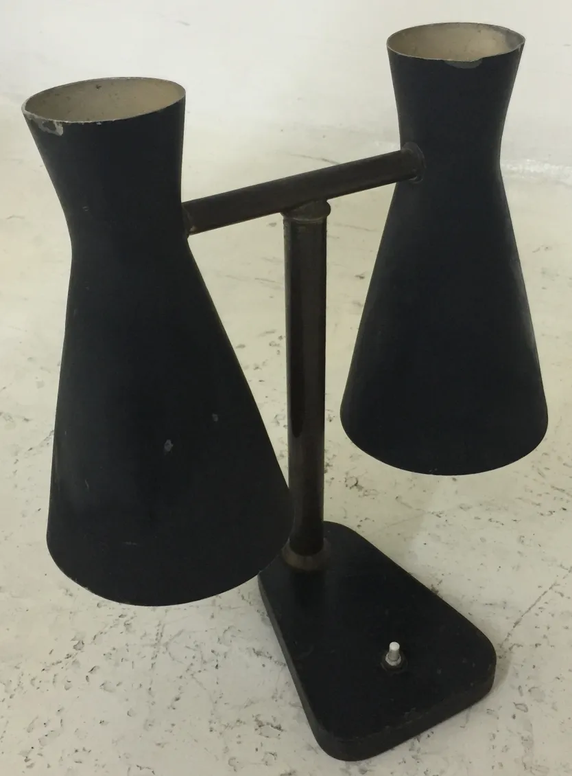 Antique table lamp with two black shades in a modern setting.