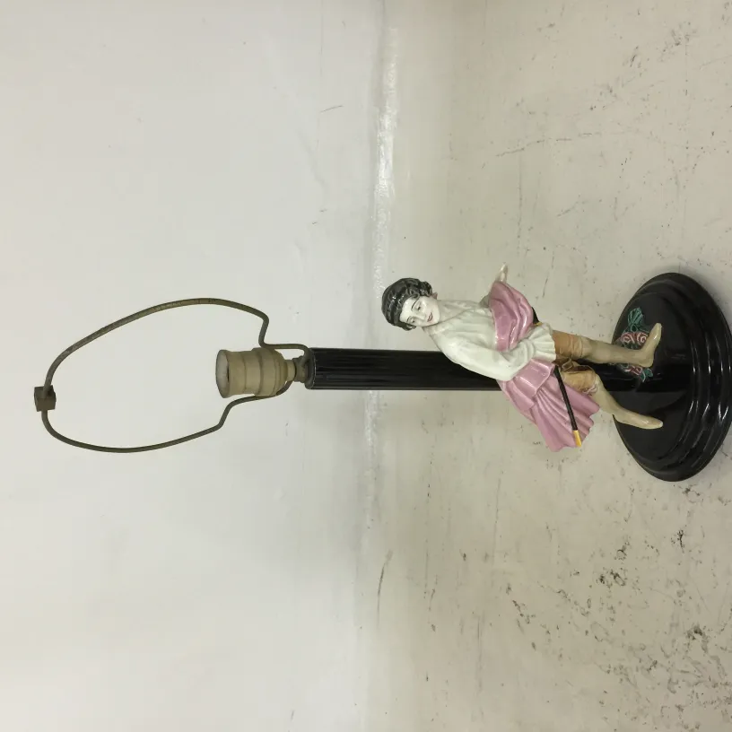 Antique table lamp with iconic figure and decorative base