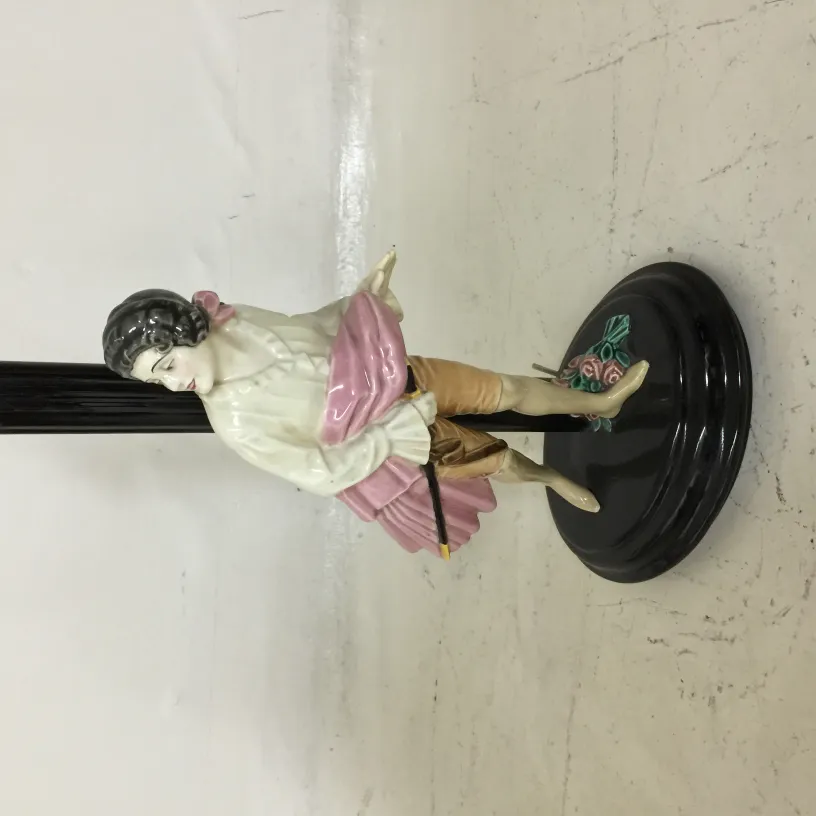 antique table lamp featuring decorative figurine on base