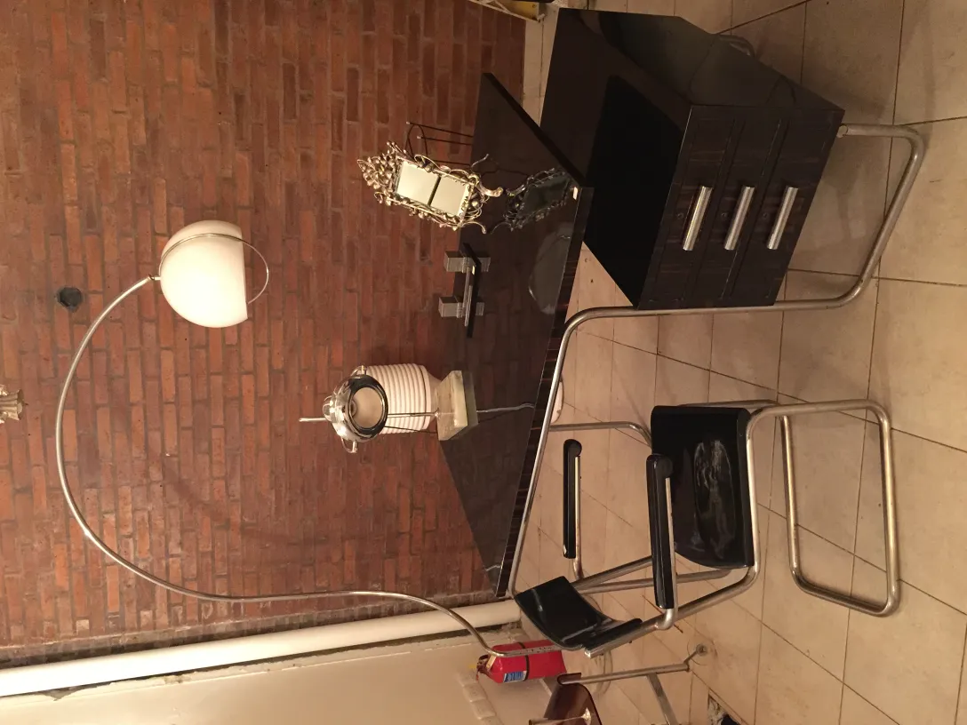 Antique table lamp with an elegant finish, set in a modern minimalist space, stands out in the room.