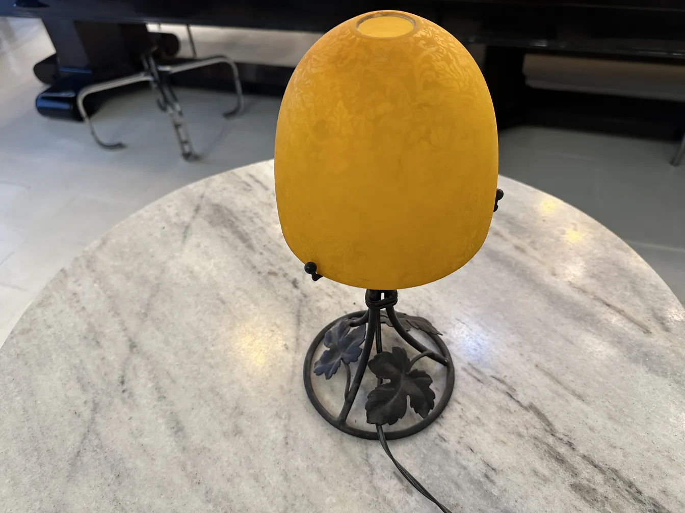 Lampada da tavolo antica con paralume giallo, design elegante, su tavolo di marmo