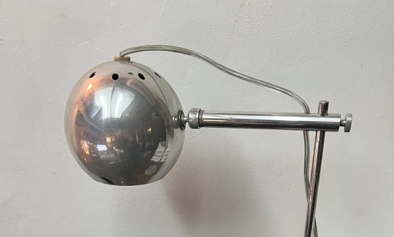 antique table lamp with spherical shape and shiny silver