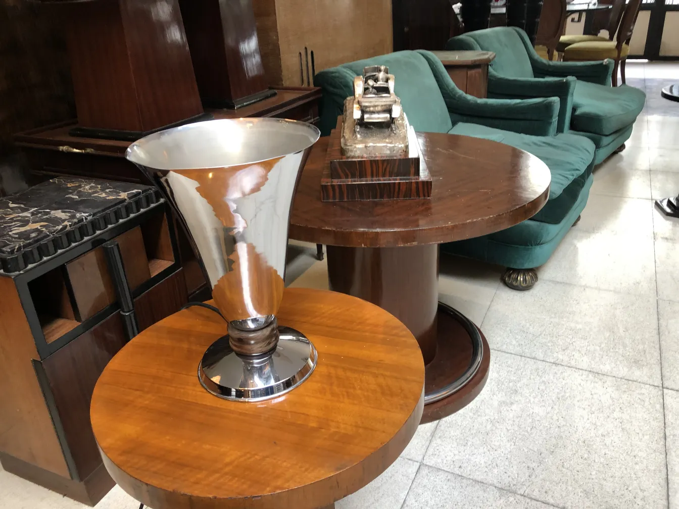 Antique table lamp with a shiny base in a stylish setting.