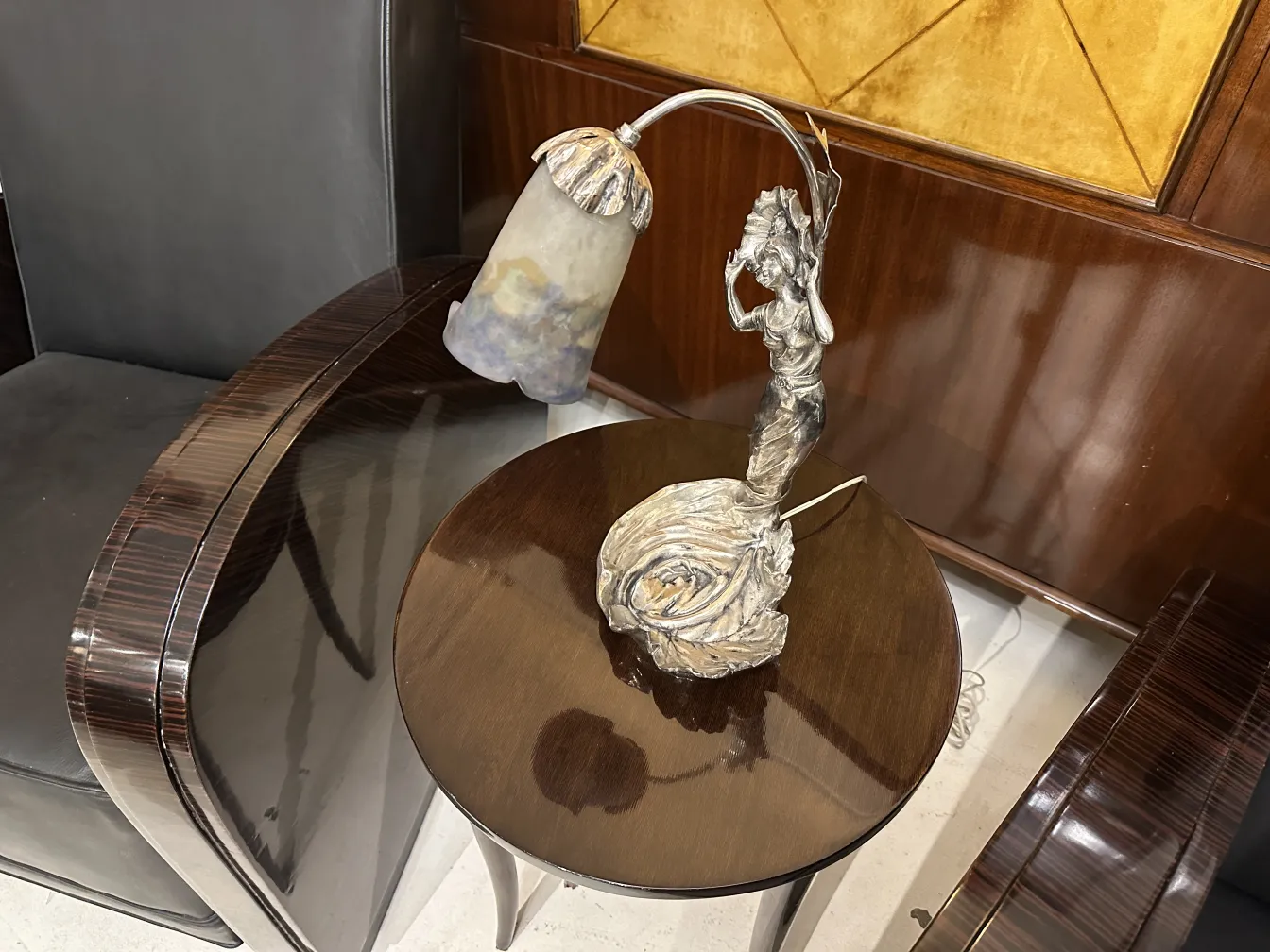 Antique table lamp with unique decorative figure on a table