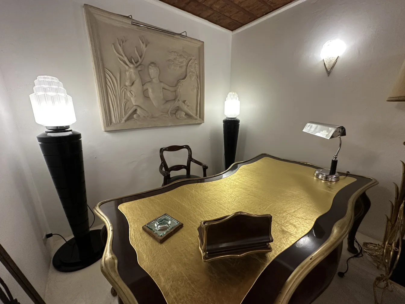 antique table lamp illuminating an elegant golden desk