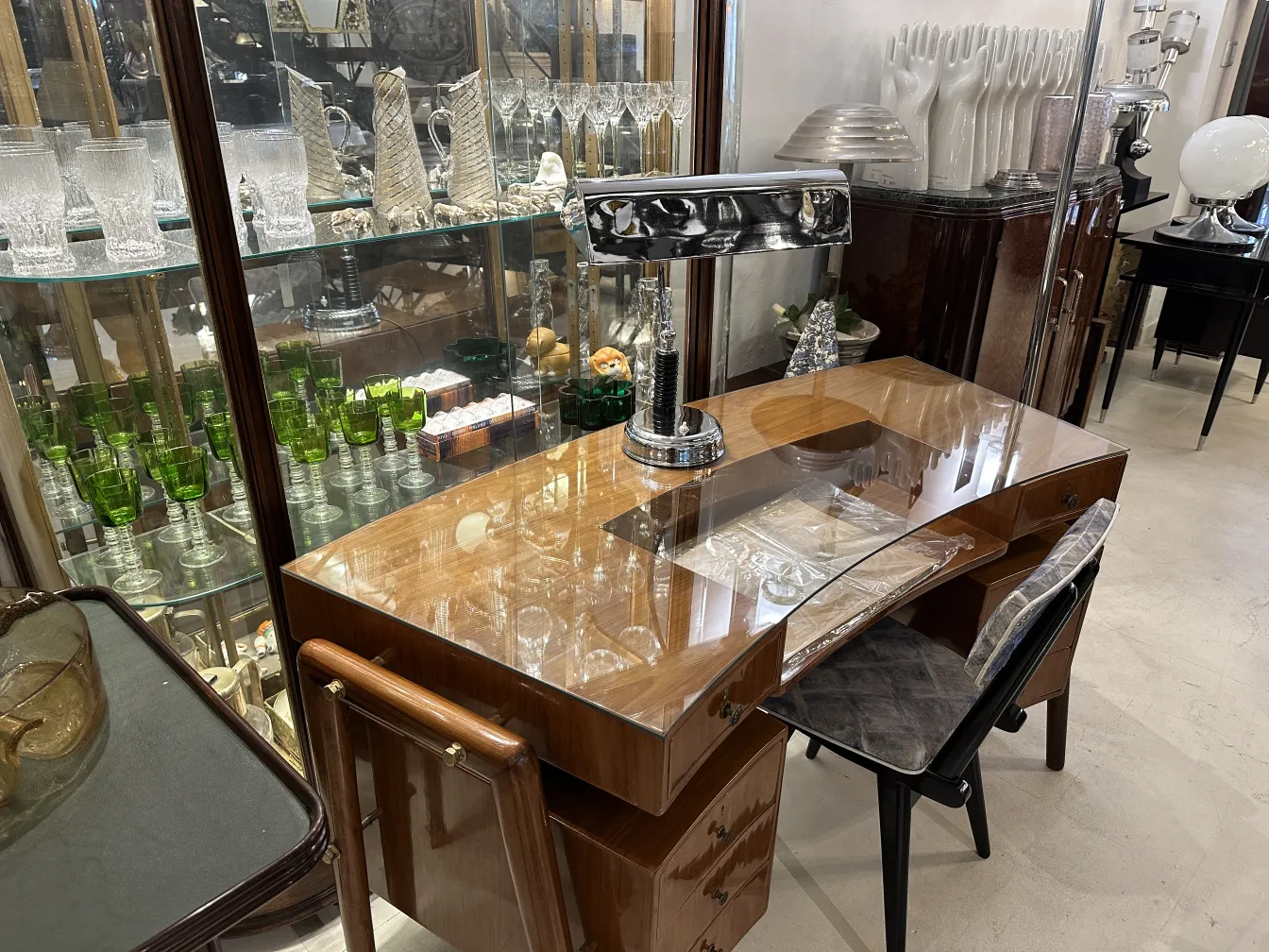 antique table lamp on an elegant desk surrounded by glassware