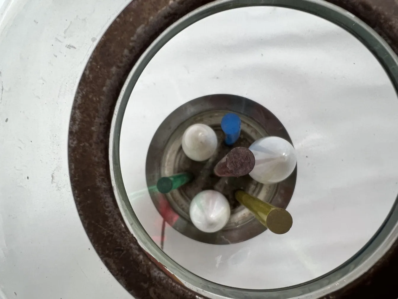 top view of an antique table lamp with various colors in a bright setting