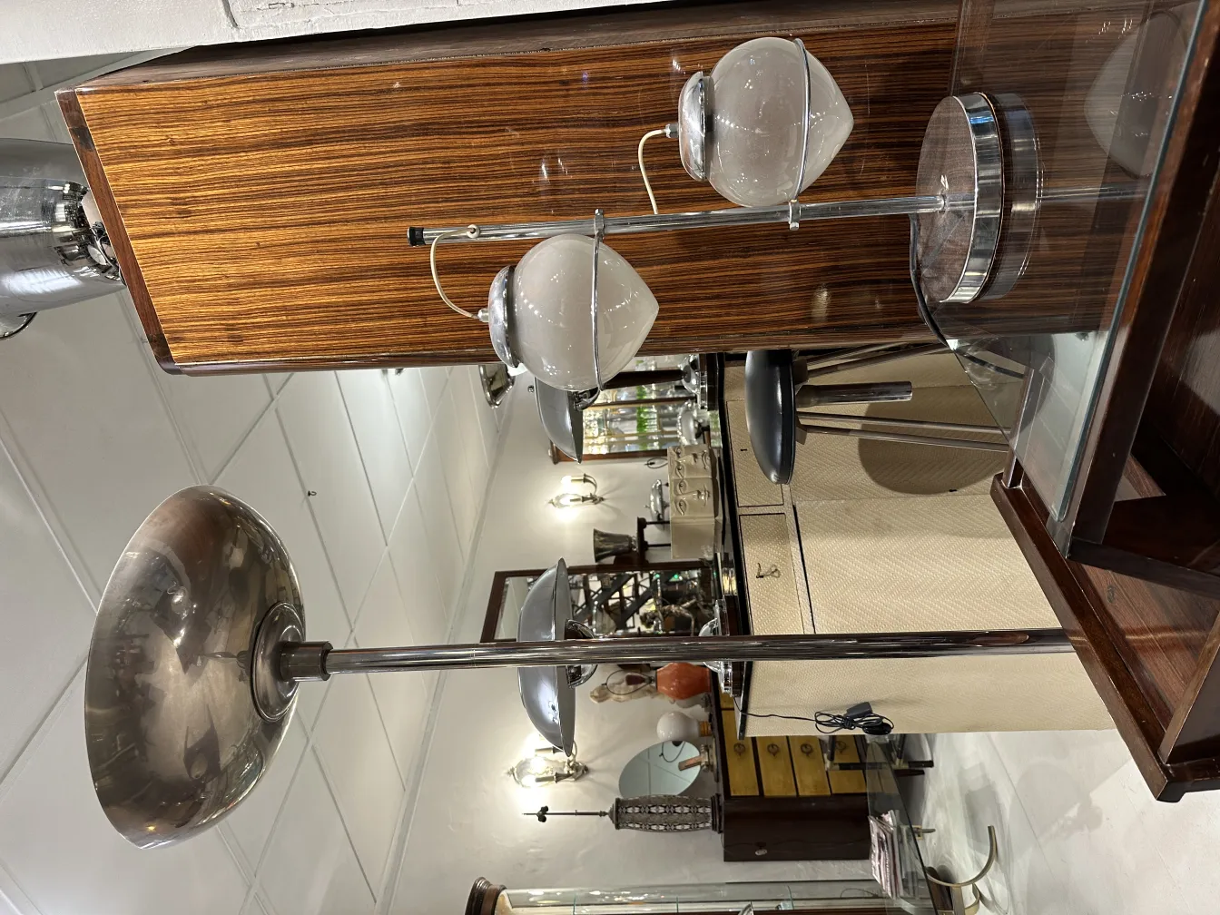 Antique table lamp with a modern base and glass shades, in an elegant setting with vintage furniture.